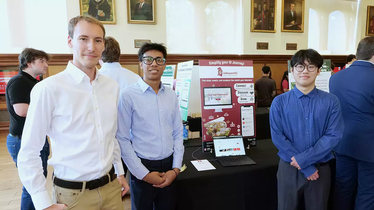 Zoheb Alvi, Aidan Kim, and Grayson Johnson presenting SideQuest IU (Team 32) at the 2026 Luddy Informatics Capstone Fair in Franklin Hall's President's Hall