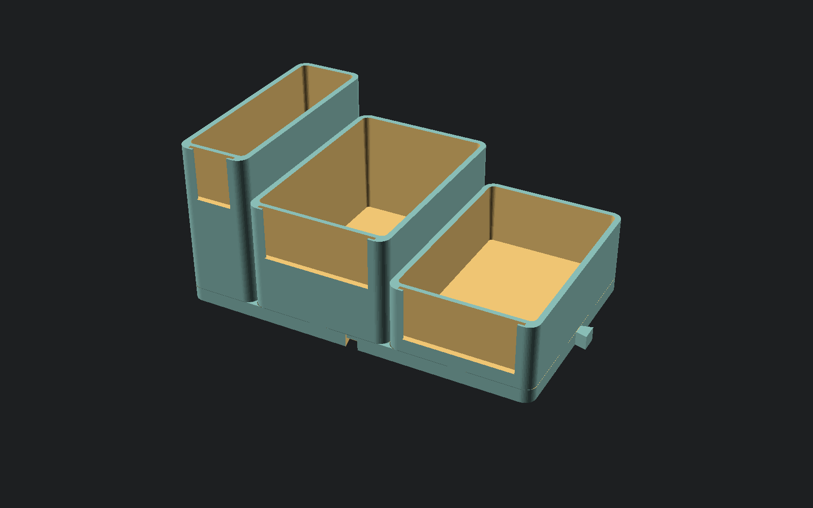 Three CoilCap boxes of different heights seated on a five-wide interlocking baseplate